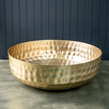 Gold hammered aluminum bowl with textured finish