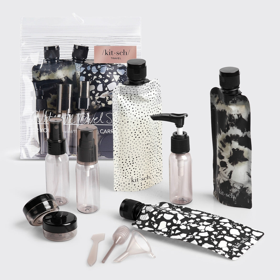 Refillable travel set with spray bottles, pump dispensers, pouches, jars, and mini tools in clear plastic.