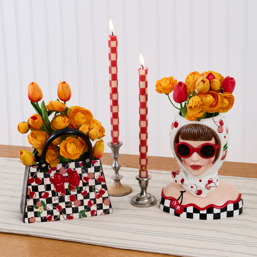 Mon Cheri Handbag Vase with a black and white checkered pattern and cherry accents holding flowers.