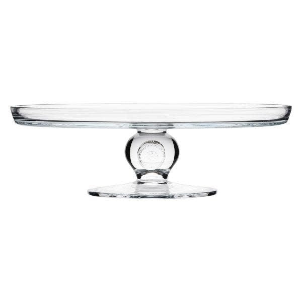 Glass cake pedestal with a clear bowl on an elevated stand.