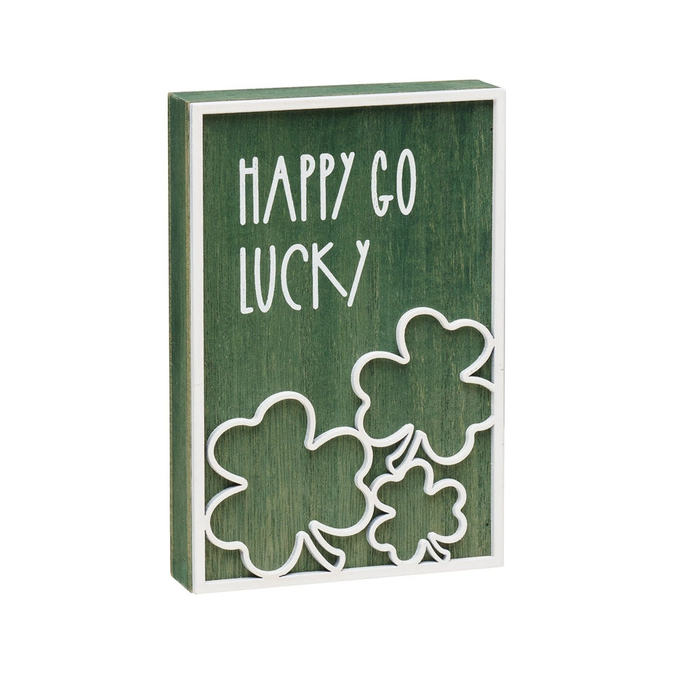 Green washed wood block with white laser cut border reading Happy Go Lucky