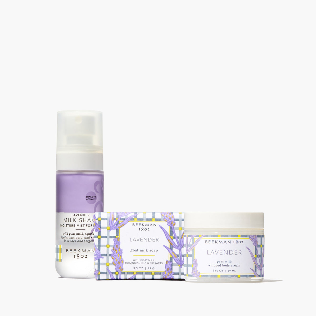 Lavender goat milk bodycare gift set with soap, whipped cream, and mist bottles.