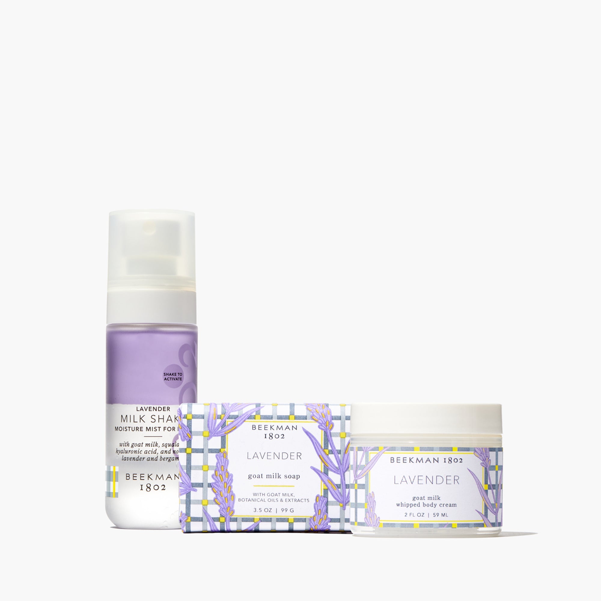 Lavender goat milk bodycare gift set with soap, whipped cream, and mist bottles.