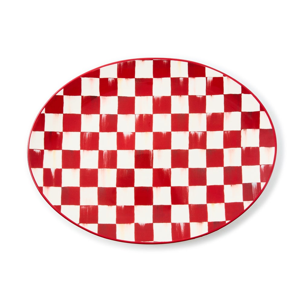 Oval stoneware serving platter with a hand-painted red and white cherry check pattern.