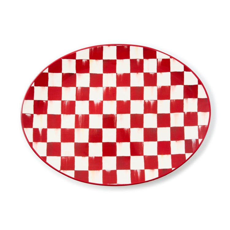 Oval stoneware serving platter with a hand-painted red and white cherry check pattern.