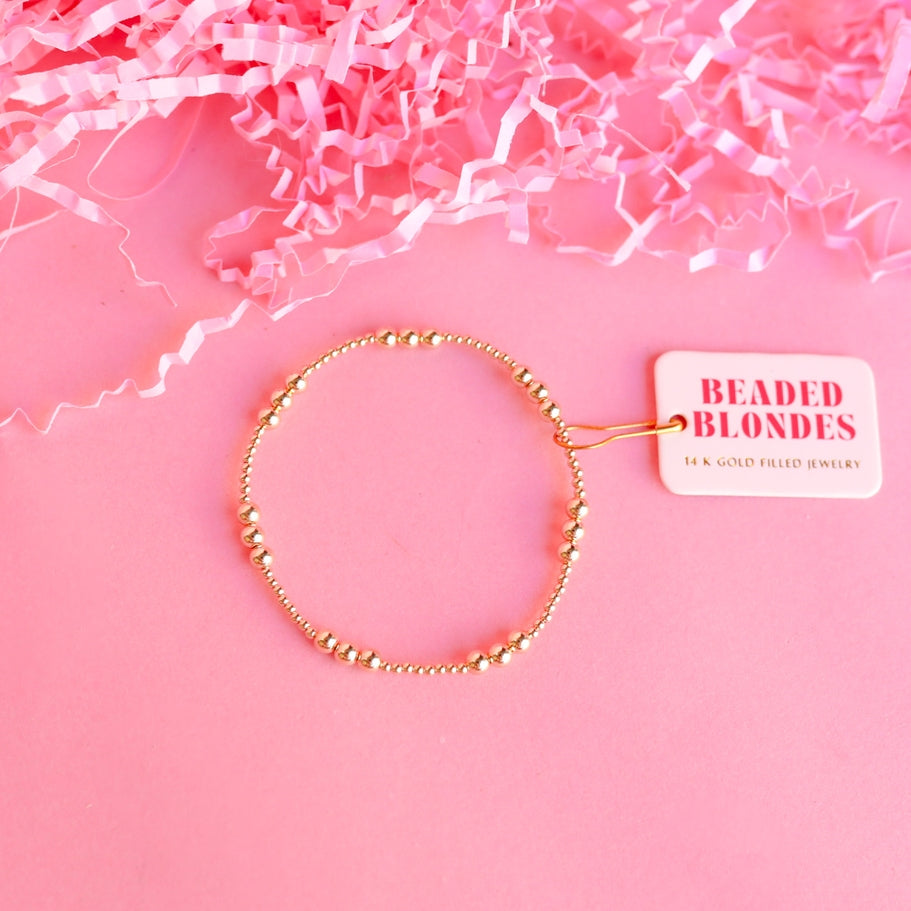 6.75-inch gold-filled Ily bracelet on an elastic string with a simple silhouette.