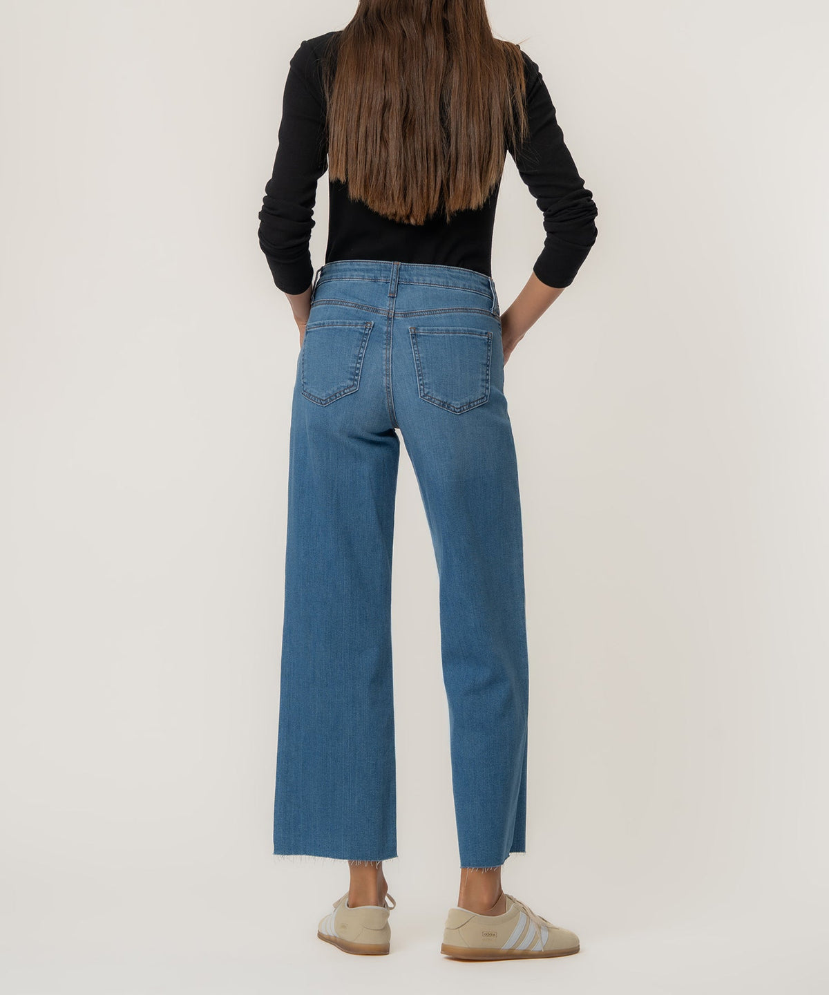 Charlotte high-rise wide-leg jeans in raw hem with a light wash denim fabric.