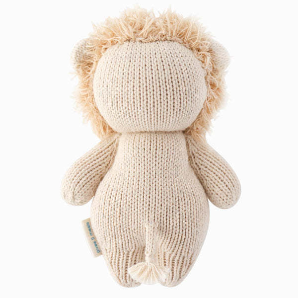 Hand-knit baby lion toy in natural cotton yarn with a soft stuffed body.