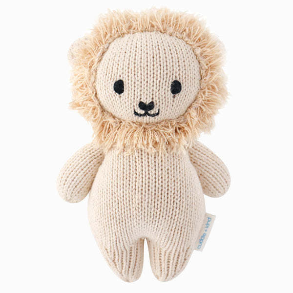 Hand-knit baby lion toy in natural cotton yarn with a soft brown silhouette.