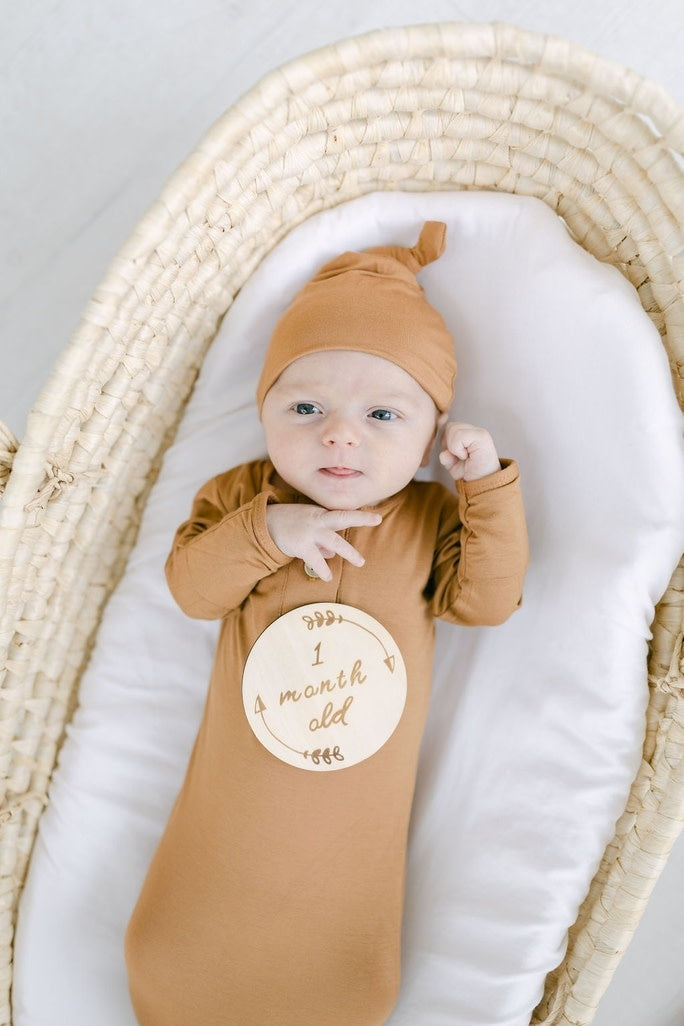 Bohemian baby milestone cards set in natural basswood with engraved text tracking growth from one week to one year.