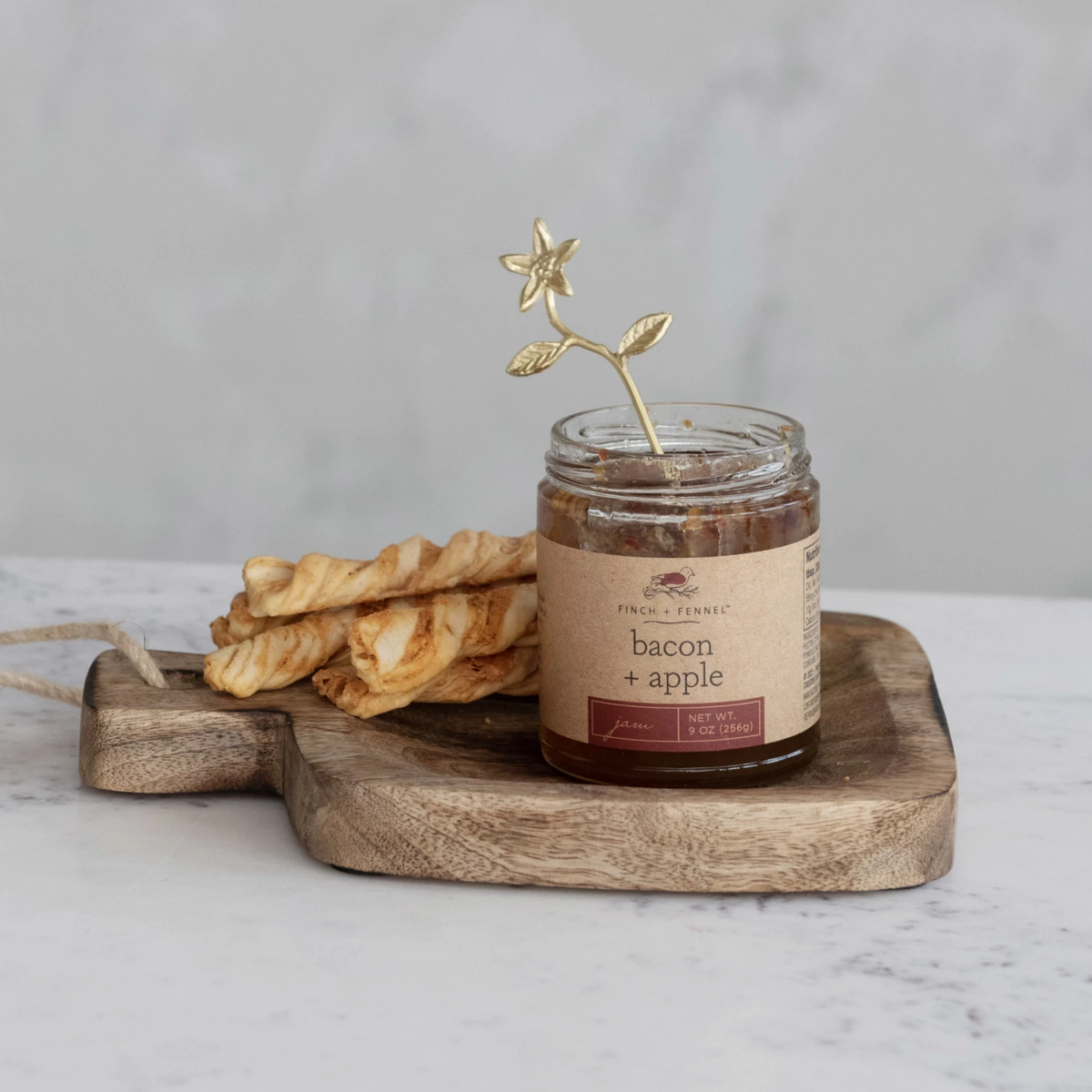 Jar of Bacon Apple Jam with visible apple chunks in a glass container.