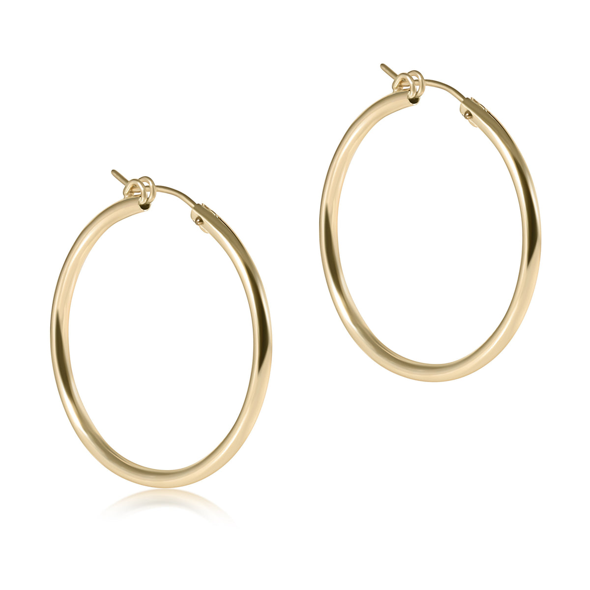 Pair of smooth, round 1.25 inch gold hoop earrings with a polished finish.
