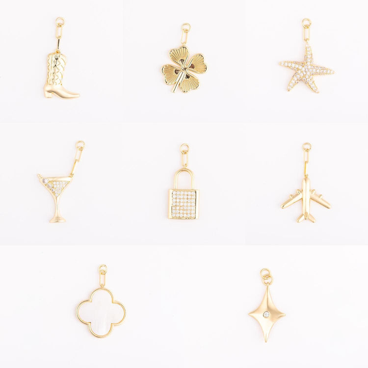 Gold-plated brass bag charm icon with a playful silhouette.