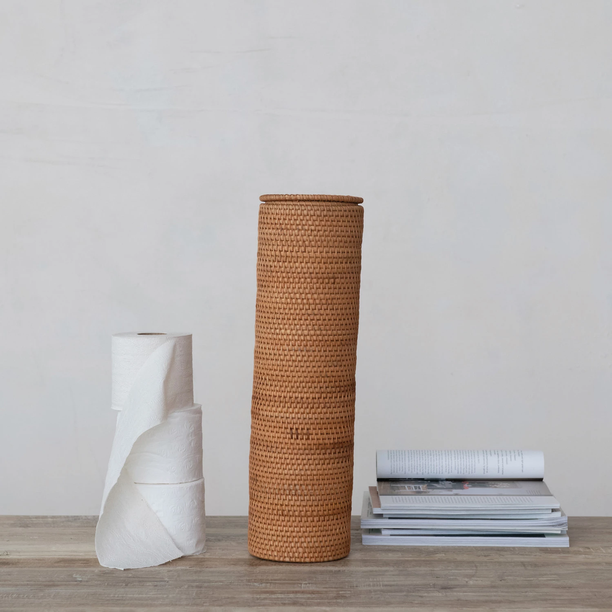 Round woven rattan toilet paper storage with lid in natural tan color
