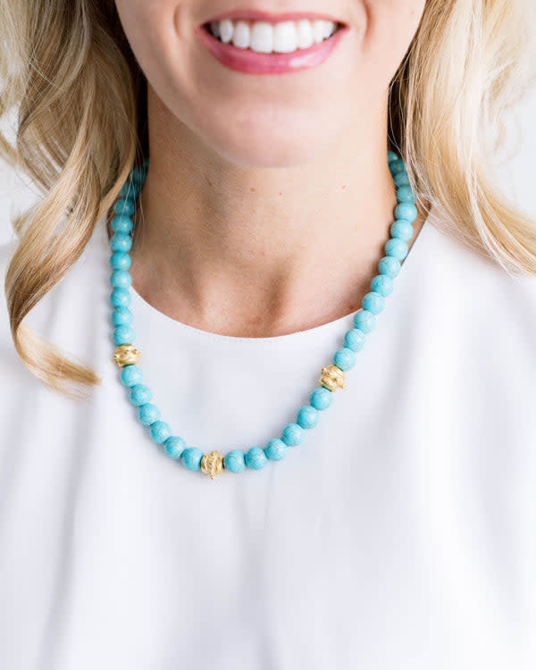 Bailey necklace with hand-strung genuine turquoise beads on a triple-plated gold chain.