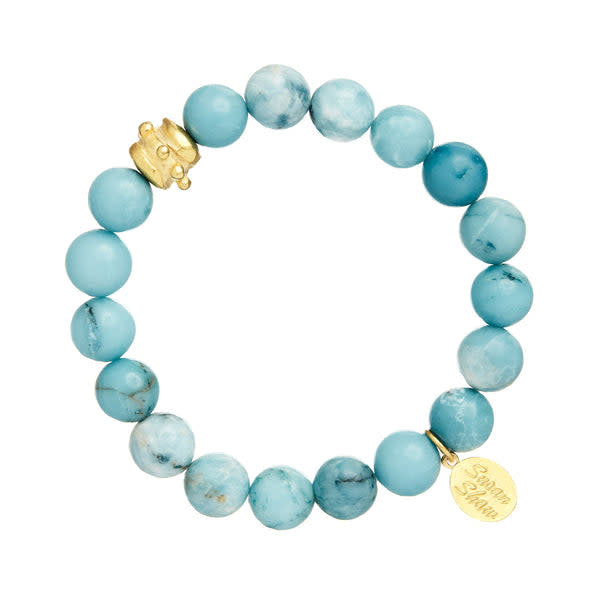 Bailey stretch bracelet with blue jasper beads and a gold Bentley accent bead.