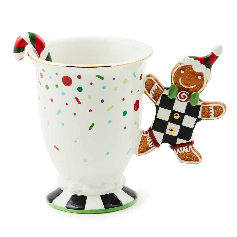 Ceramic mug with gingerbread man handle holding a spoon