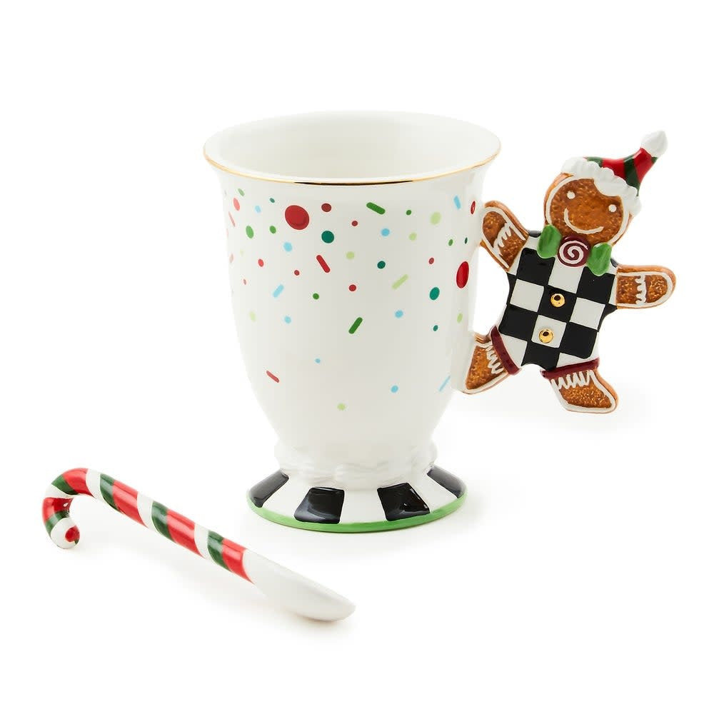 Ceramic mug with gingerbread man handle in warm tones.