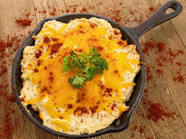 Front view of a Baked Enchilada Dip Mix package with red accents and food imagery.