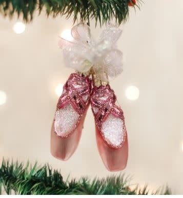 Pair of small ballet slipper ornaments in light pink satin with gold toe caps.