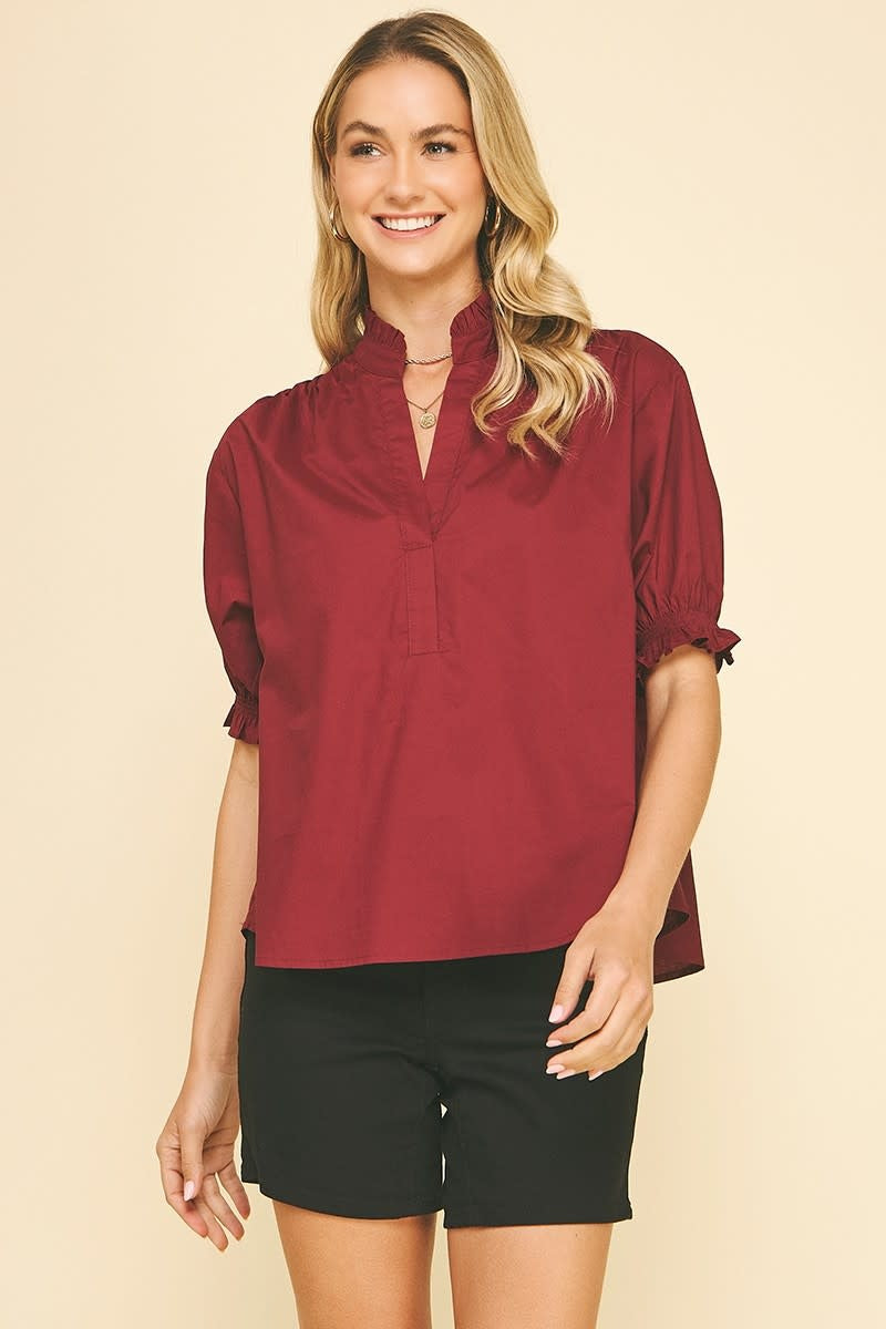 Burgundy cotton balloon sleeve blouse with V-neck ruffles.