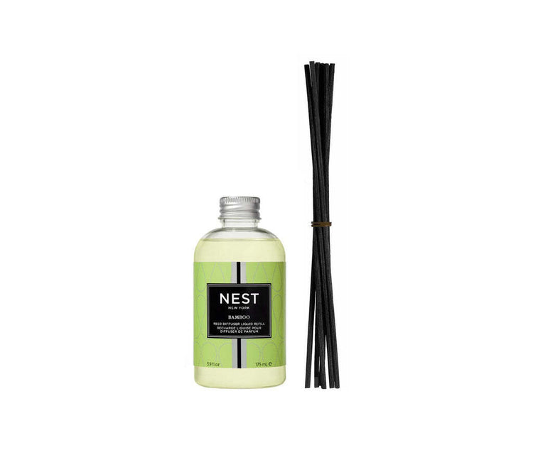 Bottle of Reed Diffuser Liquid Refill in bamboo packaging with white liquid.