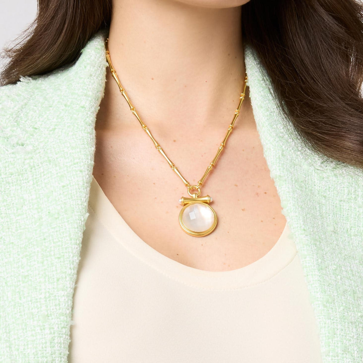 Adjustable bamboo link chain necklace with golden pendant featuring glass pearl cap over round gemstone.