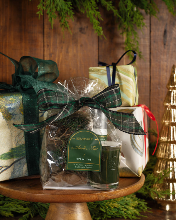 The Smell of Tree Gift Set Trio with a votive candle, room spray, and potpourri in a plaid-tied bag.