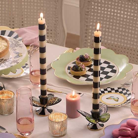 Set of black beeswax paraffin blend dinner candles with a cylindrical silhouette and smooth finish.