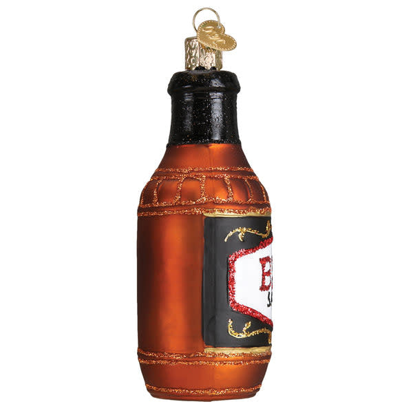 Side view of a glossy red barbecue sauce bottle ornament with white label text.