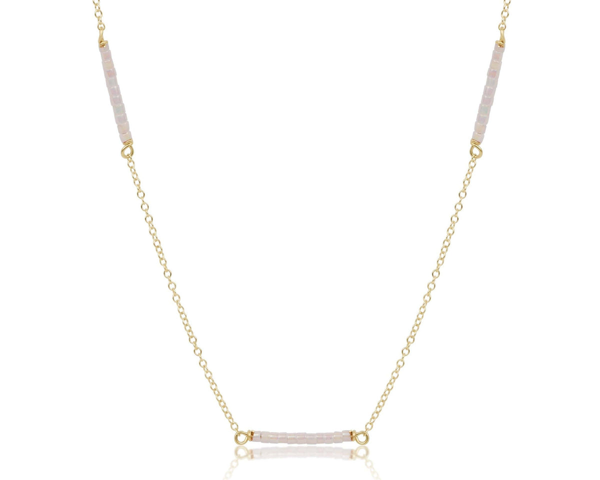 Gold-filled chain necklace with multicolored seed beads on a model