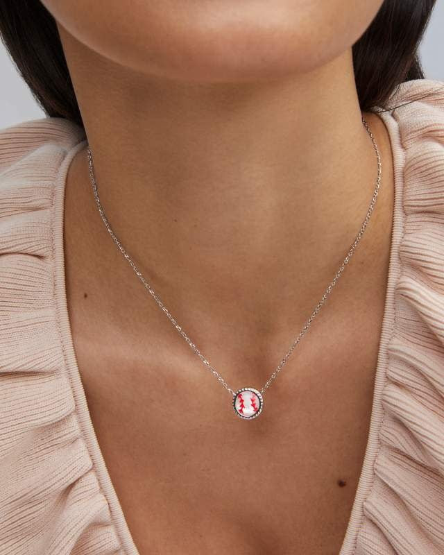 Silver chain necklace with a red enamel baseball pendant featuring white stitching detail.