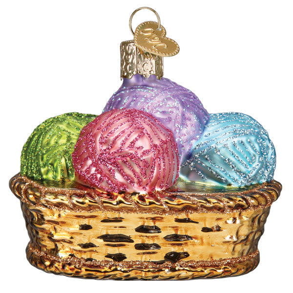 Basket ornament filled with multicolored yarn balls in a natural woven texture.