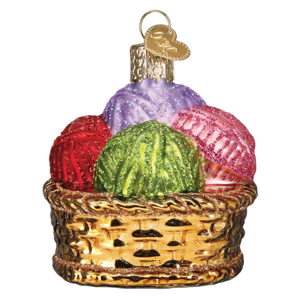 Small ceramic basket ornament filled with multicolored yarn skeins in a natural silhouette.