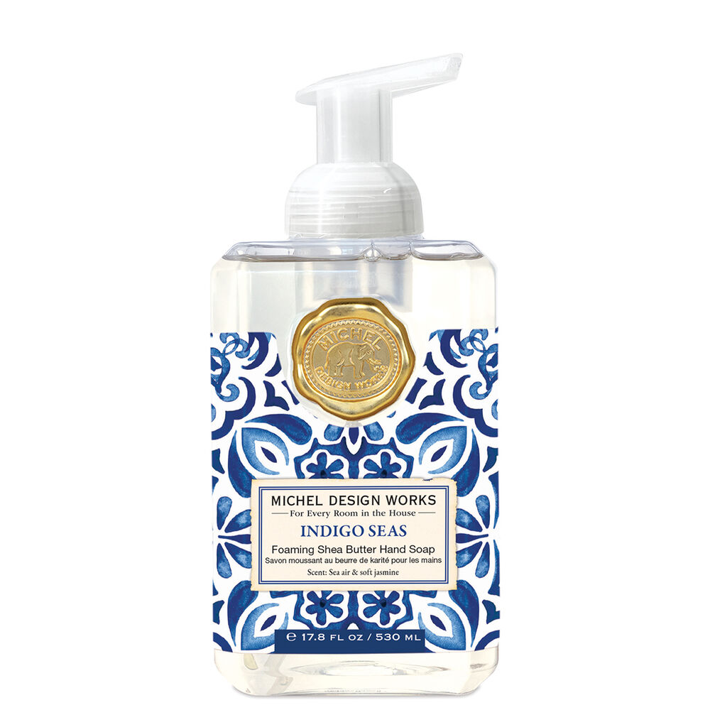 Foaming hand soap dispenser in a clear bottle with blue liquid.