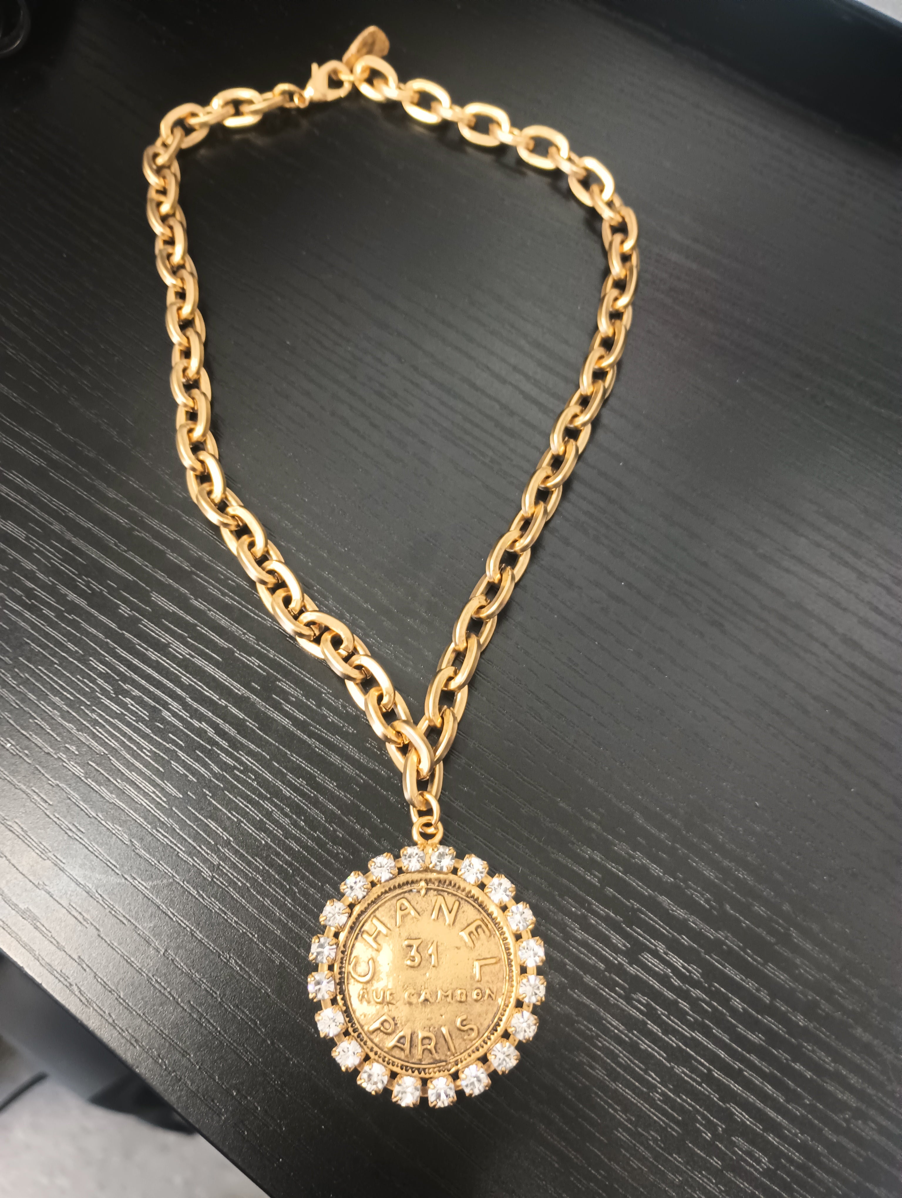 8 3/4 inch gold plated necklace with Chanel-style coin pendant featuring rhinestones