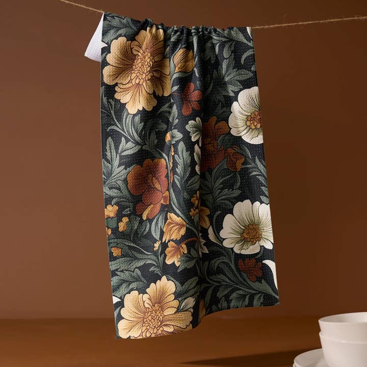 Spring-themed tea towel with waffle weave construction in light blue featuring a floral pattern.