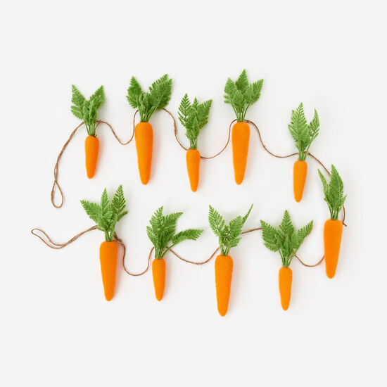 Orange flocked carrot garland with green leaf accents made from PVC and jute.