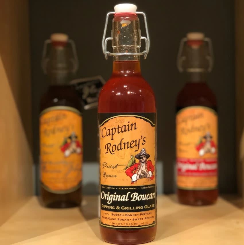 Bottle of Original Boucan Glaze Classic Edition peach barbecue sauce with a red label.