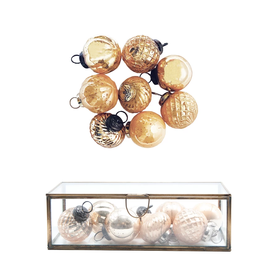 Set of embossed mercury glass ornaments in gold and champagne tones, shown loose and in a glass box.