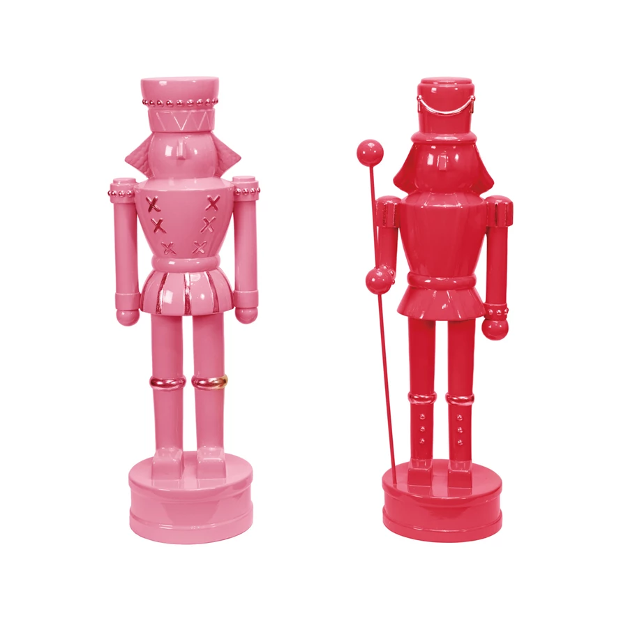 Resin nutcracker with gold finish accents on a dark background