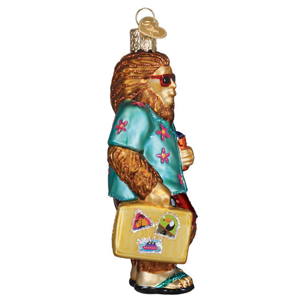 Sasquatch Gone Tropics ornament: Bigfoot figure in flip-flops and sunglasses on a beach silhouette.