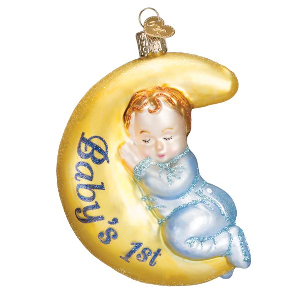 Glass ornament of a sleeping baby boy in blue pajamas resting on a yellow crescent moon.