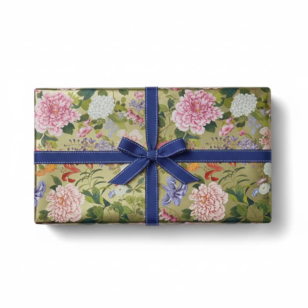 A Profusion Of Flowers Gold Foil Gift Wrap with floral patterns and a blue ribbon bow.