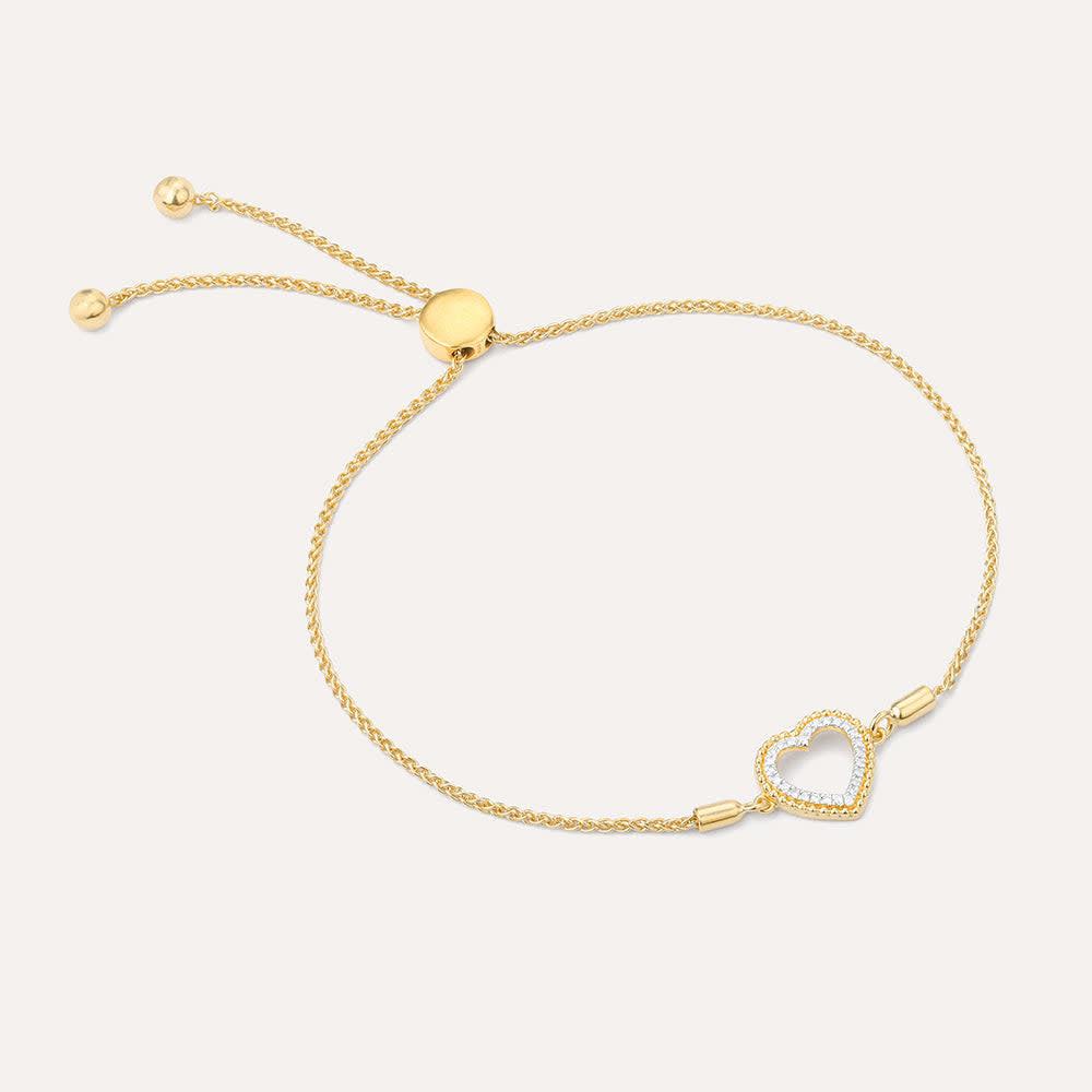 Adjustable bolo bracelet with a diamond-studded heart pendant on gold-plated sterling silver chain.
