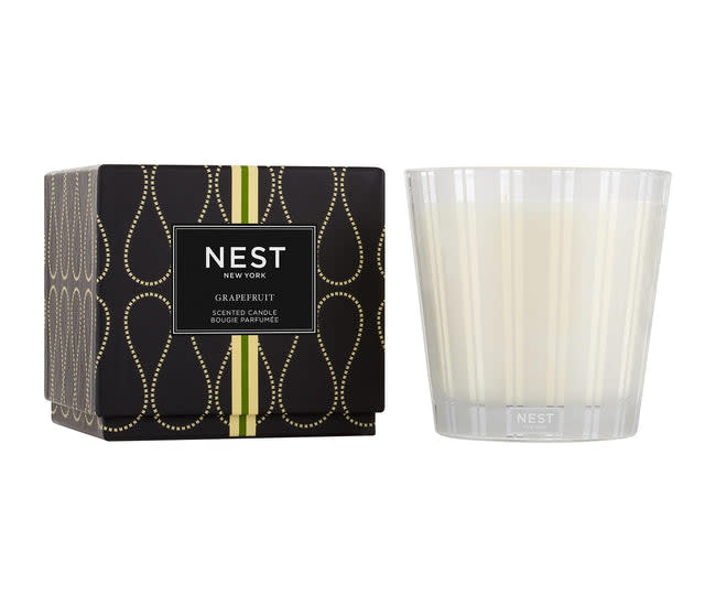Nest 3-Wick Candle in a cylindrical glass jar with three wicks and a neutral label.