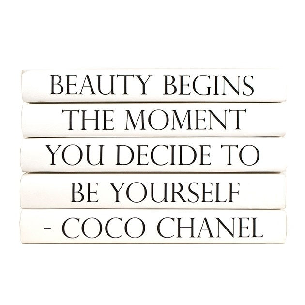 Five-volume decorative book stack with sleek black covers featuring Beauty by Coco Chanel branding.