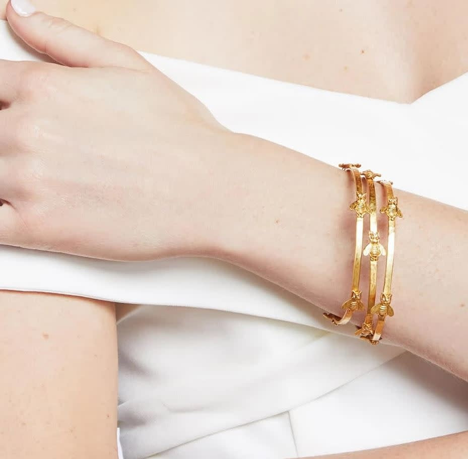 Medium gold-plated bangle with hammered texture featuring whimsical bee stations accented by sparkling CZ eyes.