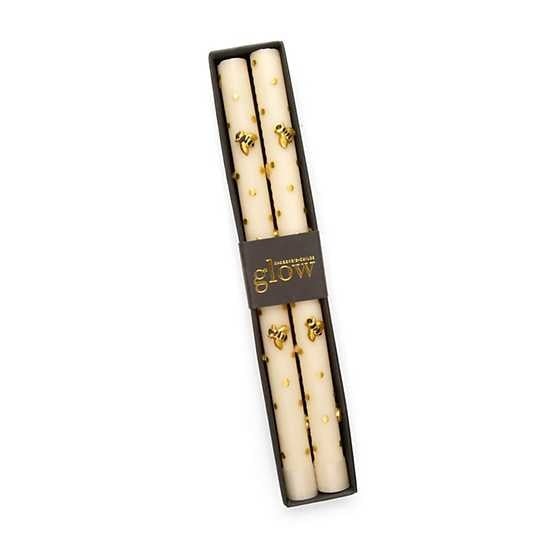 Set of pure beeswax dinner candles with warm golden hue