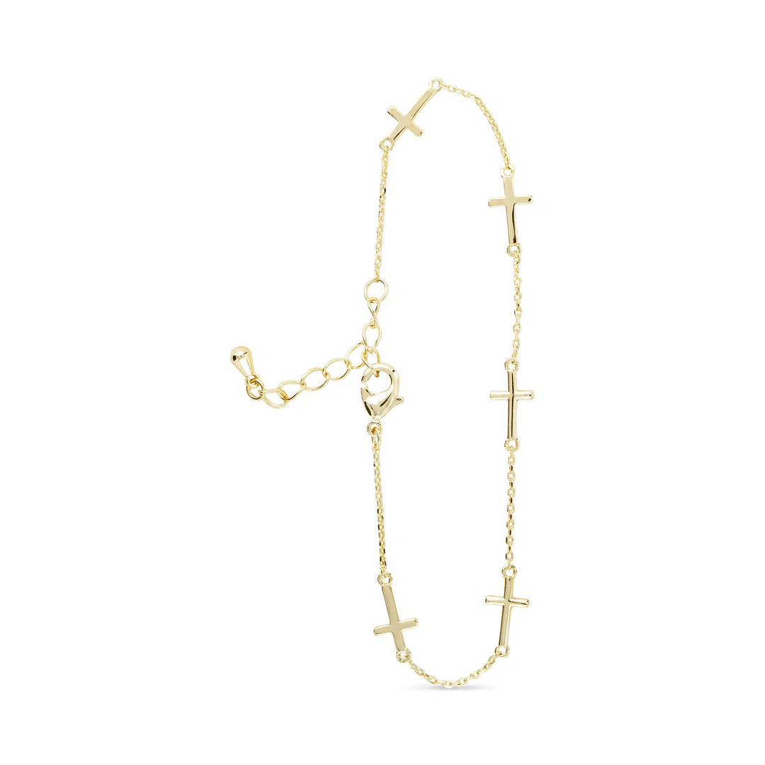 Gold station bracelet with five small cross charms on a fine chain with an adjustable clasp.